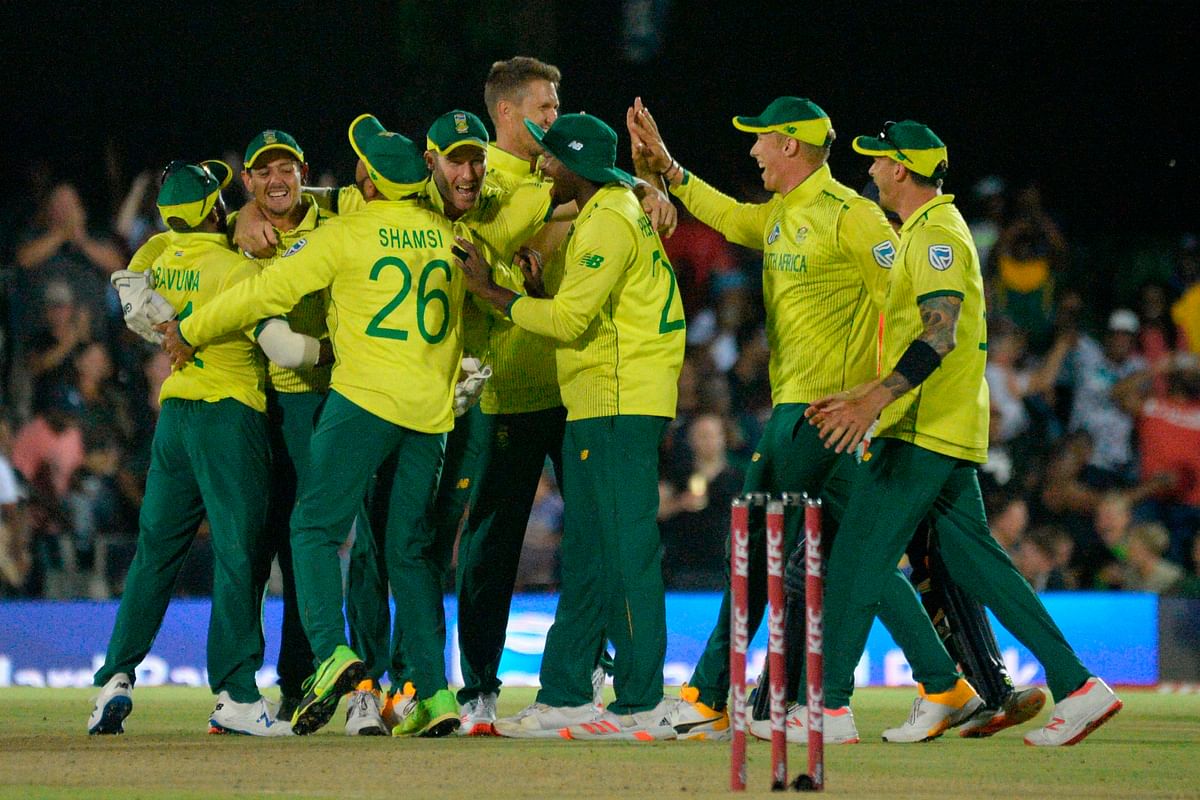 South Africa`s captain Quinton de Kock (2nd L) celebrates with teammates their victory over England during the first T20 cricket match between South Africa and England at the Buffalo Park Cricket Grounds in East London on 12 February 2020. Photo: AFP