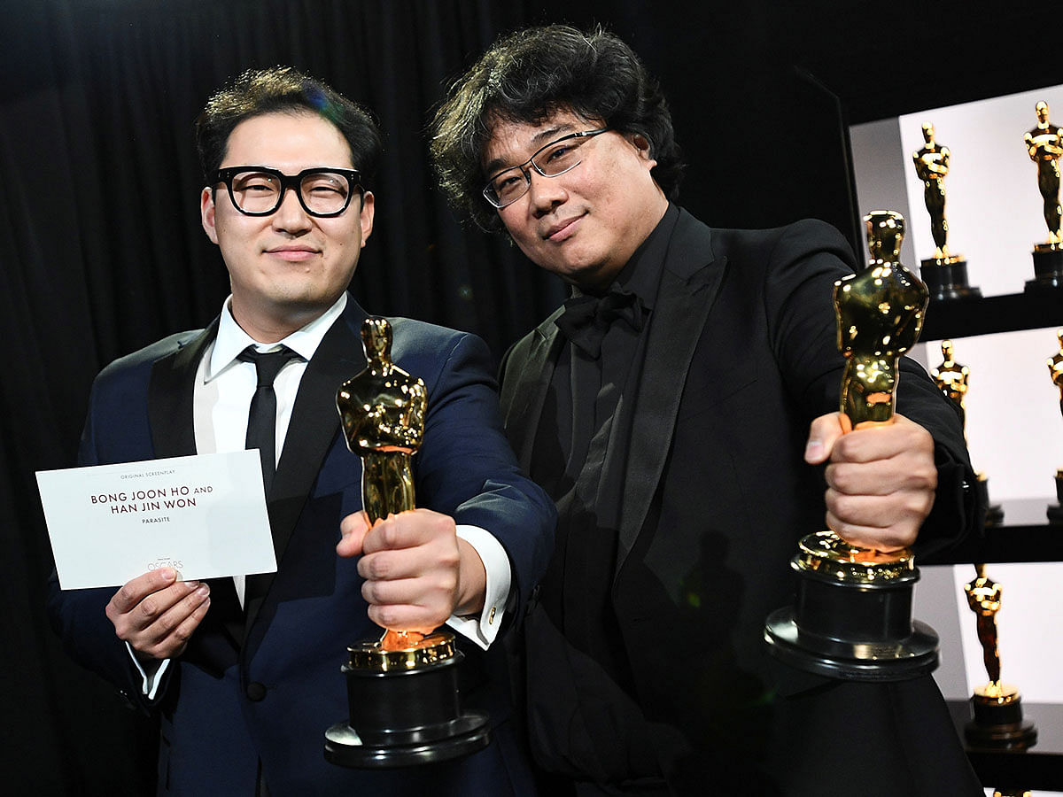 Bong Joon Ho and Han Jin Won hold their Oscar statues for Original Screenplay for `Parasite` at the 92nd Academy Awards in Hollywood, Los Angeles, California, US on 9 February. Photo: Reuters