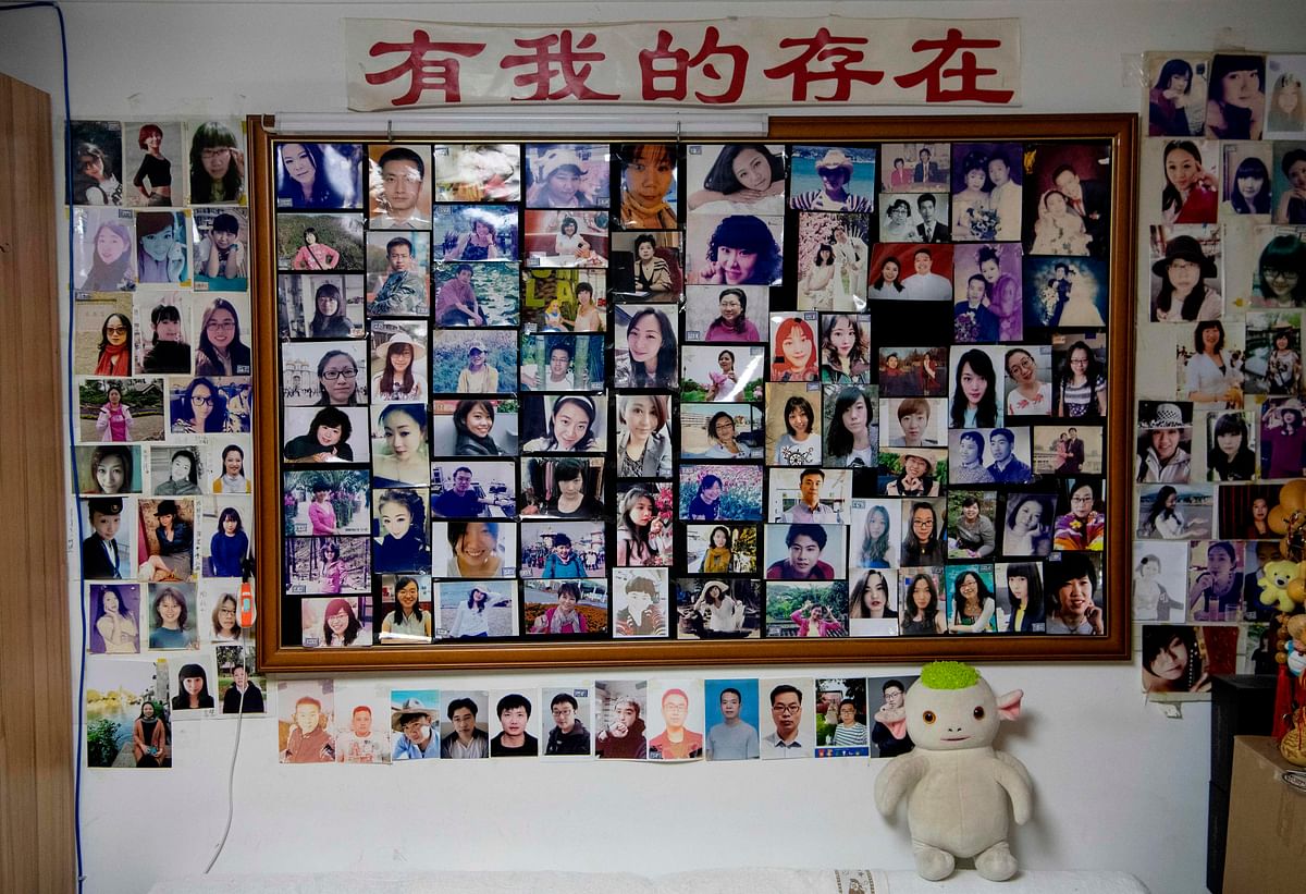 This photo taken on 17 December 2019 shows the walls of the house of matchmaker Zhu Fang covered with the images of single women who have come to him over the years in Beijing. Photo: AFP