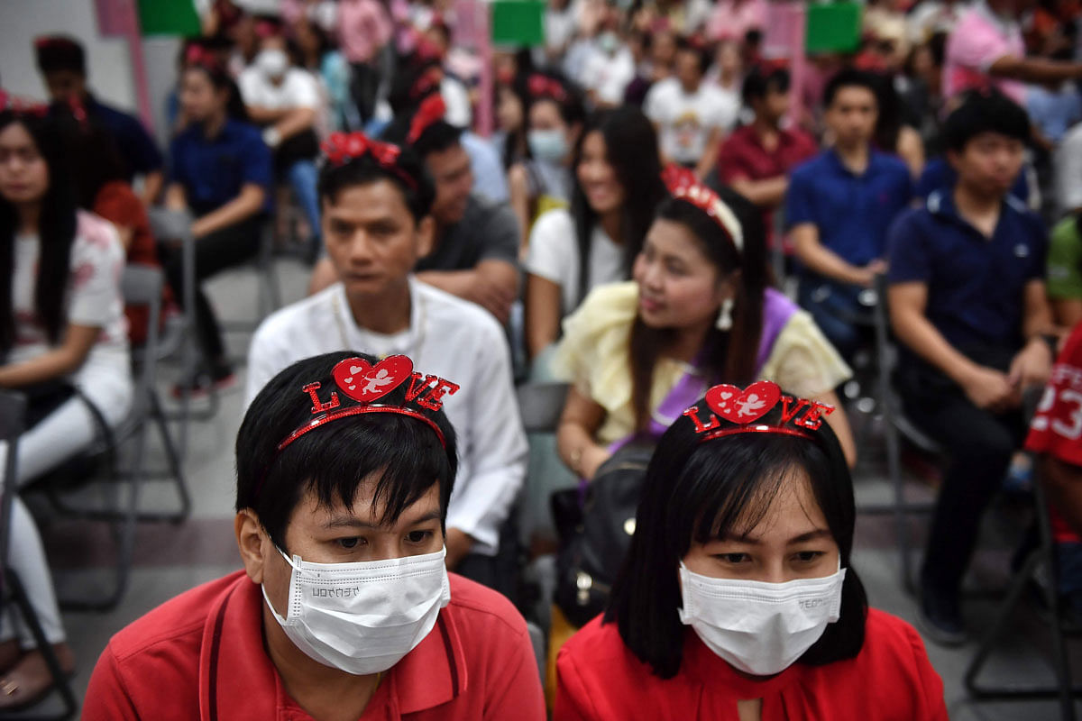Couples in protective facemasks wait to register their marriage licences on Valentine`s Day in Bang Rak, the Thai capital`s `district of love,` in Bangkok on 14 February 2020. Photo: AFP