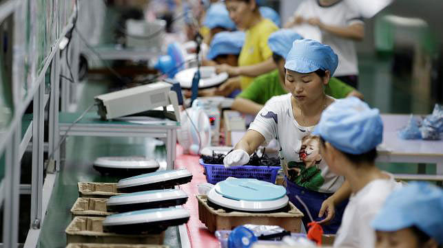 Employees work on the production line of a robot vacuum cleaner at a factory of Matsutek in Shenzhen. Photo: Reuters