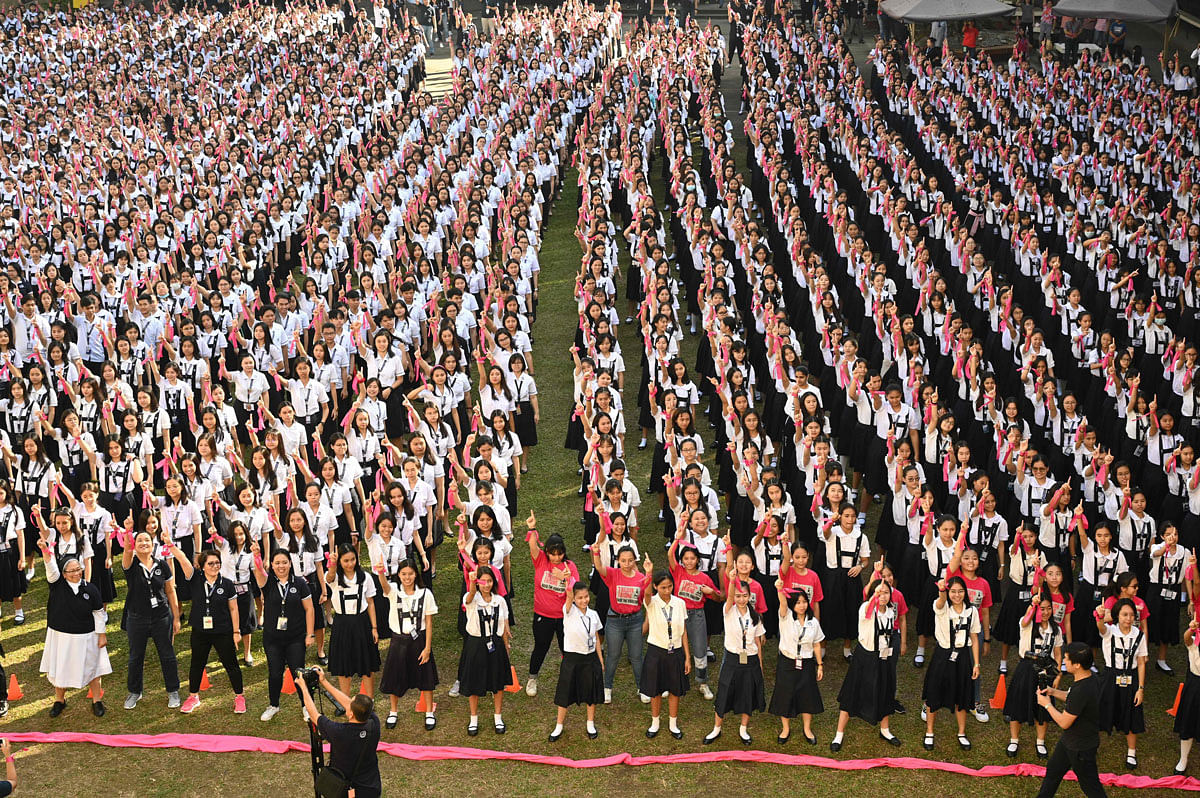 Students of St. Scholastica`s College gesture the `number one` sign as they dance to take part in the `One Billion Rising` global movement in Manila on 14 February 2020, to coincide with Valentine`s Day. More 3,000 students participated as part of the campaign, calling for an end of all forms of discrimination and violence against women and children. Photo: AFP