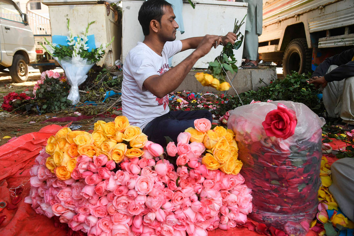 A vendor prepares a flower bouquet at a roadside stall ahead of Valentine`s Day in Karachi. Photo: AFP