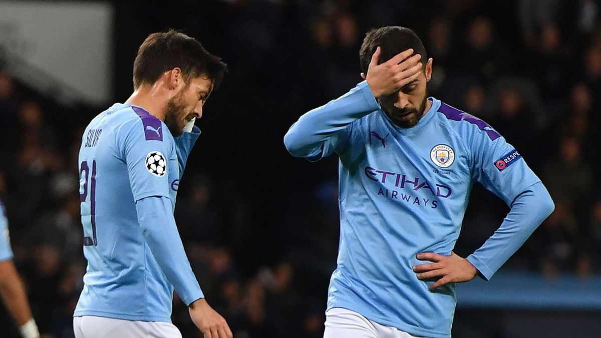 In this file photo taken on 1 October 2019, Manchester City’s Spanish midfielder David Silva (L) and Manchester City’s Portuguese midfielder Bernardo Silva ® react to a missed chance during the UEFA Champions League Group C football match between Manchester City and Dinamo Zagreb at the Etihad Stadium in Manchester, north west England. Photo: AFP