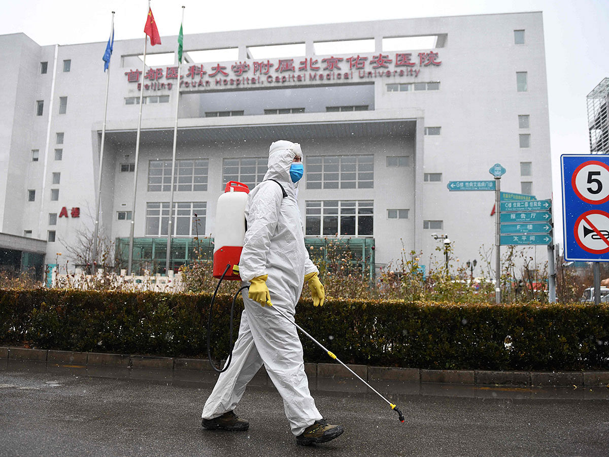 A worker sterilises a path at the Youan Hospital in Beijing on 14 February 2020. Photo: AFP