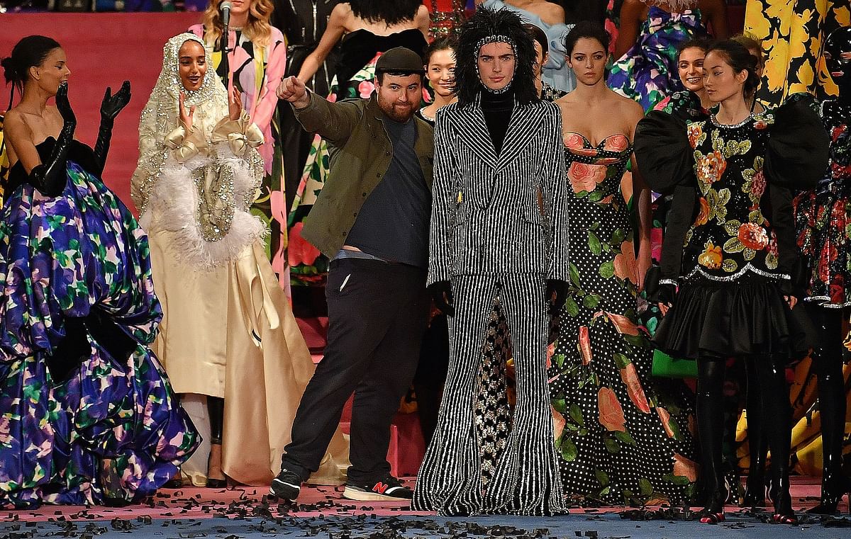 British fashion designer Richard Quinn (centre L) poses with his models after presenting his catwalk show for the Autumn/Winter 2020 collection on the second day of London Fashion Week in London on 15 February.Photo: AFP