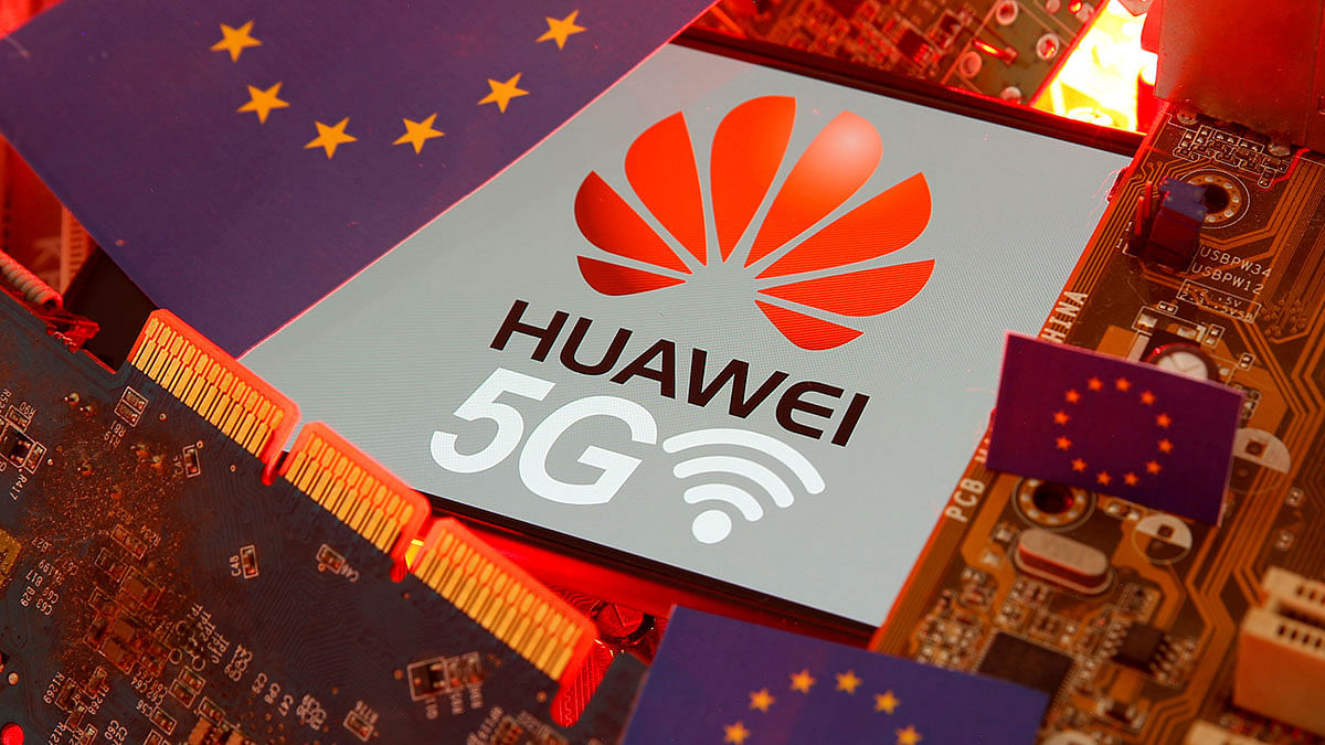 The EU flag and a smartphone with the Huawei and 5G network logo are seen on a PC motherboard in this illustration taken January