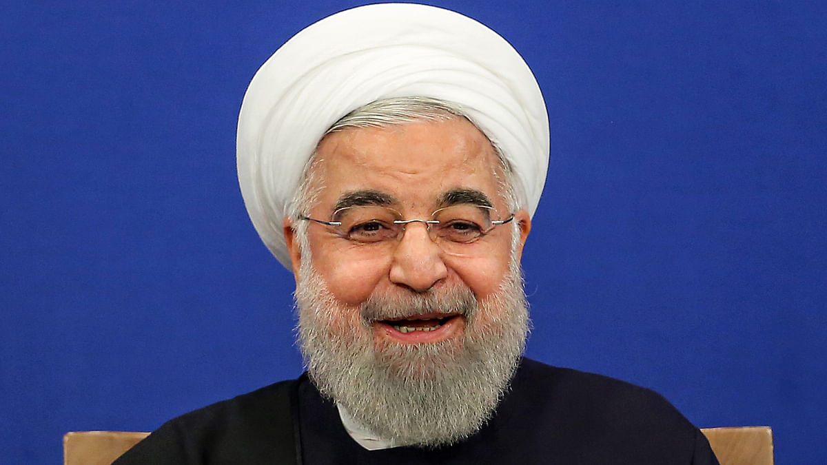 Iranian President Hassan Rouhani speaks during a news conference in the capital Tehran, on 16 February 2020, with the portraits of Iran`s (L to R) former and current Supreme Leaders, Ayatollah Ruhollah Khomeini and Ayatollah Ali Khamenei, seen behind. Photo: AFP