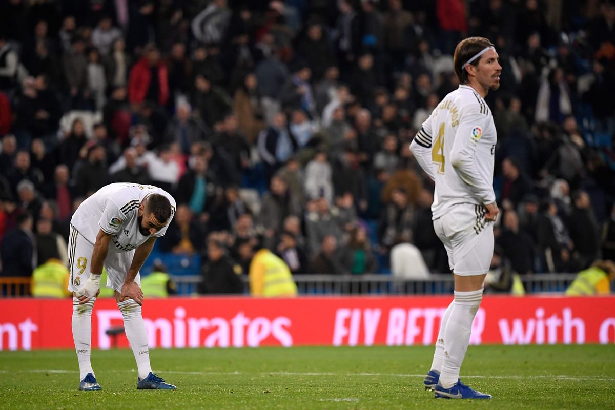 Real Madrid`s Spanish defender Sergio Ramos (R) and Real Madrid`s French forward Karim Benzema react after the Spanish league football match between Real Madrid CF and RC Celta de Vigo at the Santiago Bernabeu stadium in Madrid on 16 February, 2020. Photo: AFP