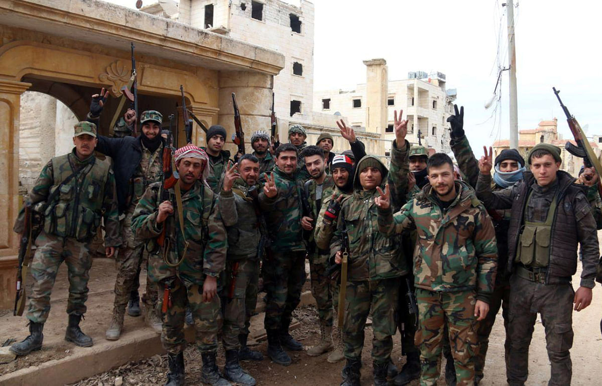 Syrian army soldiers gesture in al-Rashideen area in Aleppo province, Syria, in this handout released by SANA on 16 February. Photo: Reuters