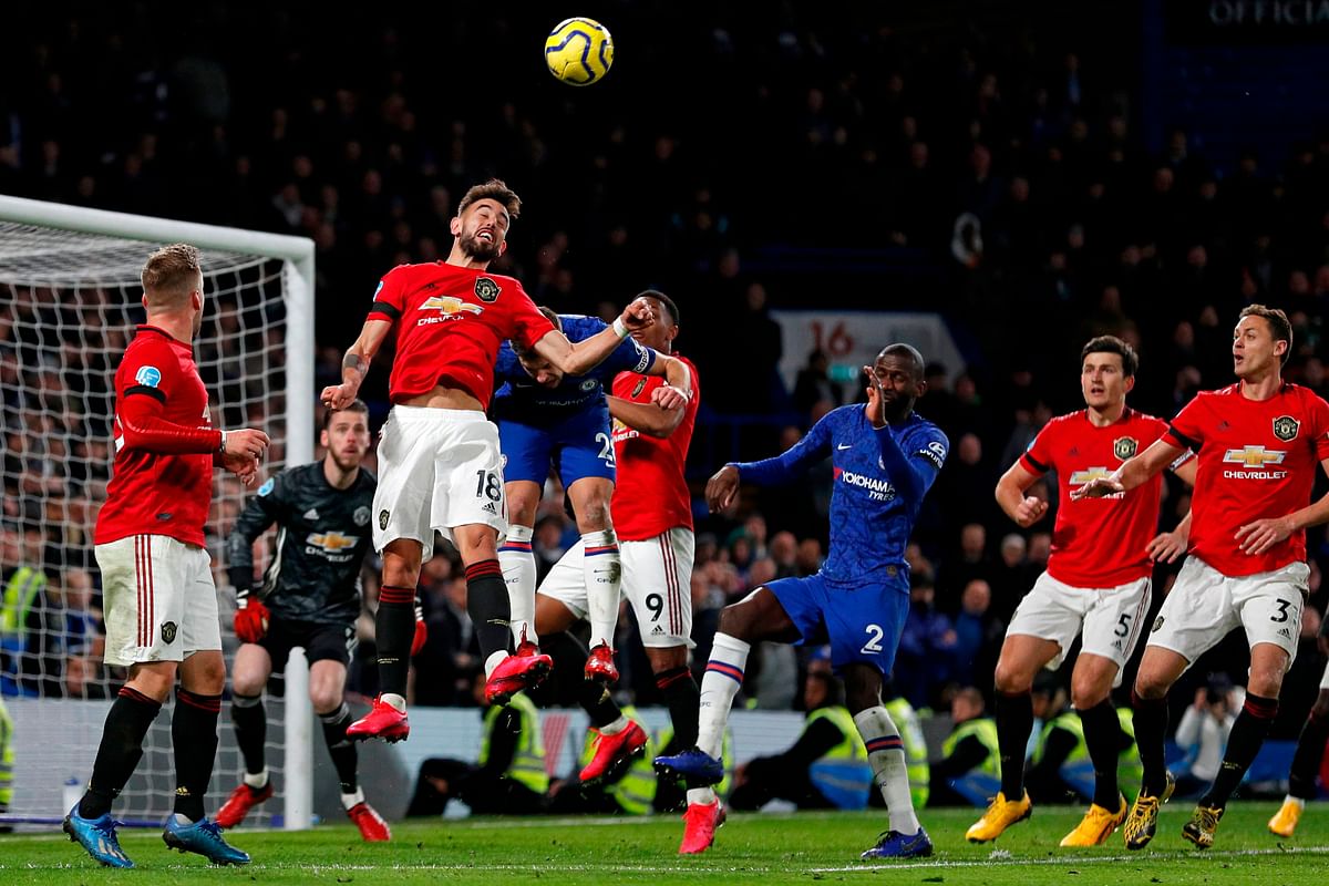 Manchester United`s Portuguese midfielder Bruno Fernandes (C) jumps to win a header during the English Premier League football match between Chelsea and Manchester United at Stamford Bridge in London on 17 February, 2020. Photo: AFP