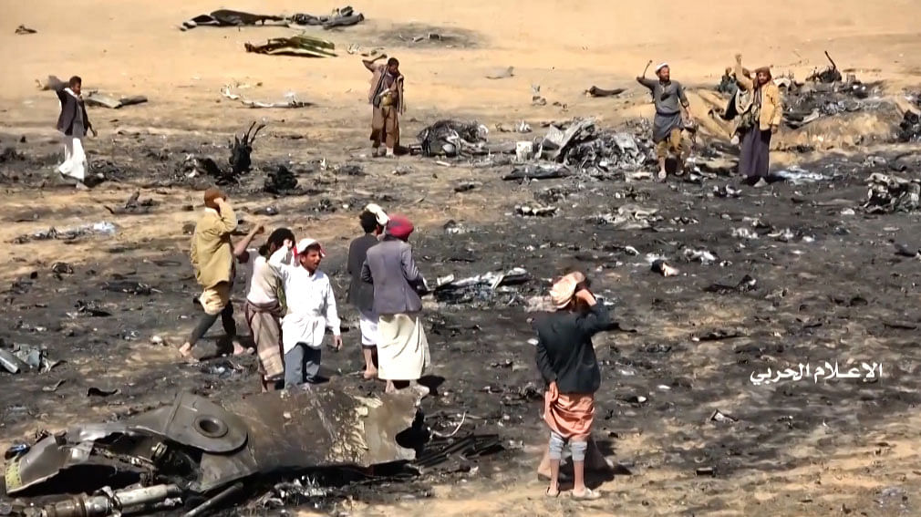 This image grab taken from a video released by al-Huthi Military Media Office on 15 February shows Yemenis gathering at the site of the downing of a Saudi Tornado aircraft following an air strike by Iran-backed Huthi rebels in Yemen`s northern Al-Jawf province. Photo: AFP