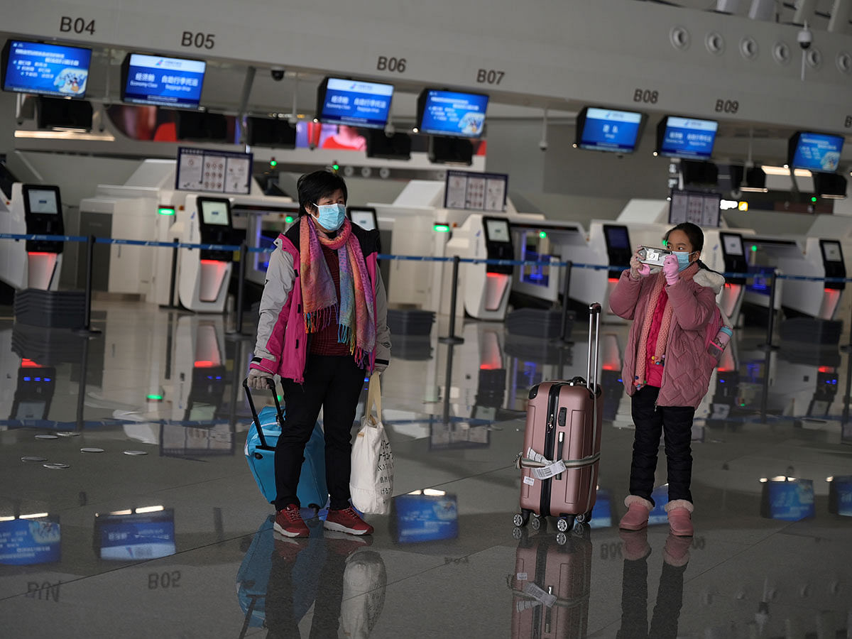 Passengers wearing face masks are seen with their suitcases at the Beijing Daxing International Airport, as the country is hit by an outbreak of the novel coronavirus, in Beijing, China on 20 February 2020. Photo: Reuters