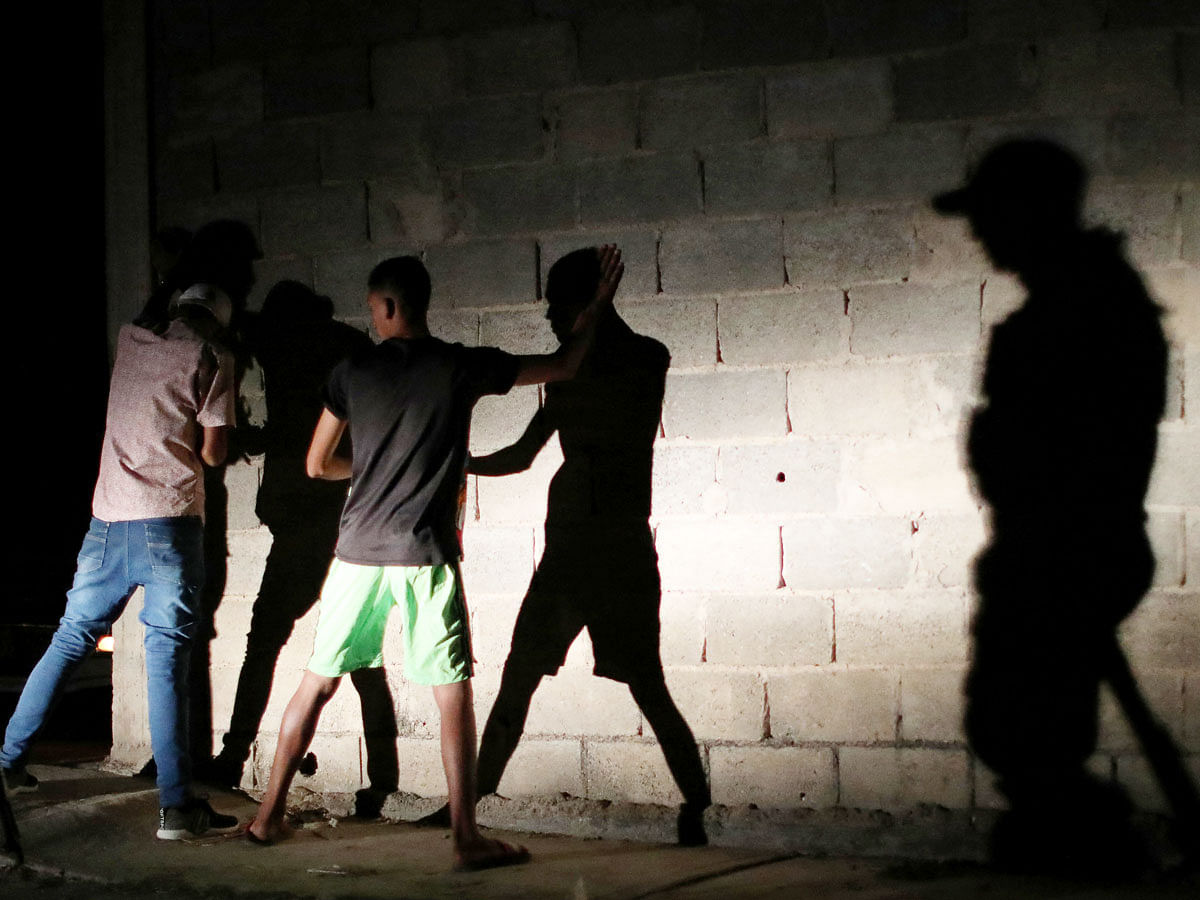 Members of the Special Action Force of the Venezuelan National Police (FAES) stop people during a night patrol, in Barquisimeto, Venezuela on 20 September 2019. Photo: Reuters