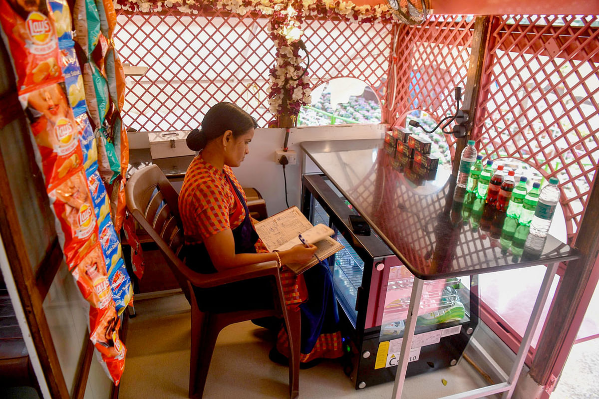 This photo taken on 9 February 2020 shows an attendant taking stock of supplies inside a mobile toilet on a bus at a public park in Pune. Photo: AFP