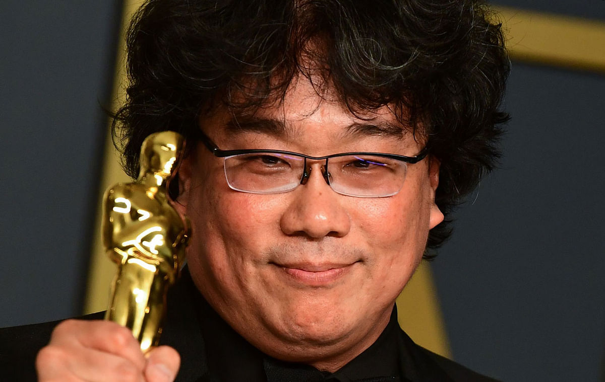 In this file photo `Parasite` director Bong Joon-ho pose in the press room with his Oscars during the 92nd Oscars at the Dolby Theater in Hollywood, California on 9 February 2020. Photo: AFP