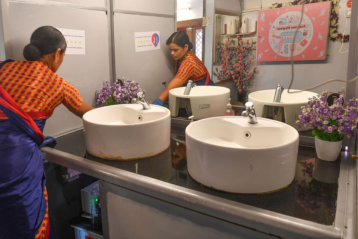 This photo taken on 9 February 2020 shows an attendant cleaning the interior of a mobile toilet on a bus at a public park in Pune. Launched in 2016 by entrepreneurs Ulka Sadalkar and Rajeev Kher, the `Ti Toilet` project -- `ti` means `her` in the local Marathi language -- has 11 mobile washrooms, which are on average used by more 200 women daily. Photo: AFP