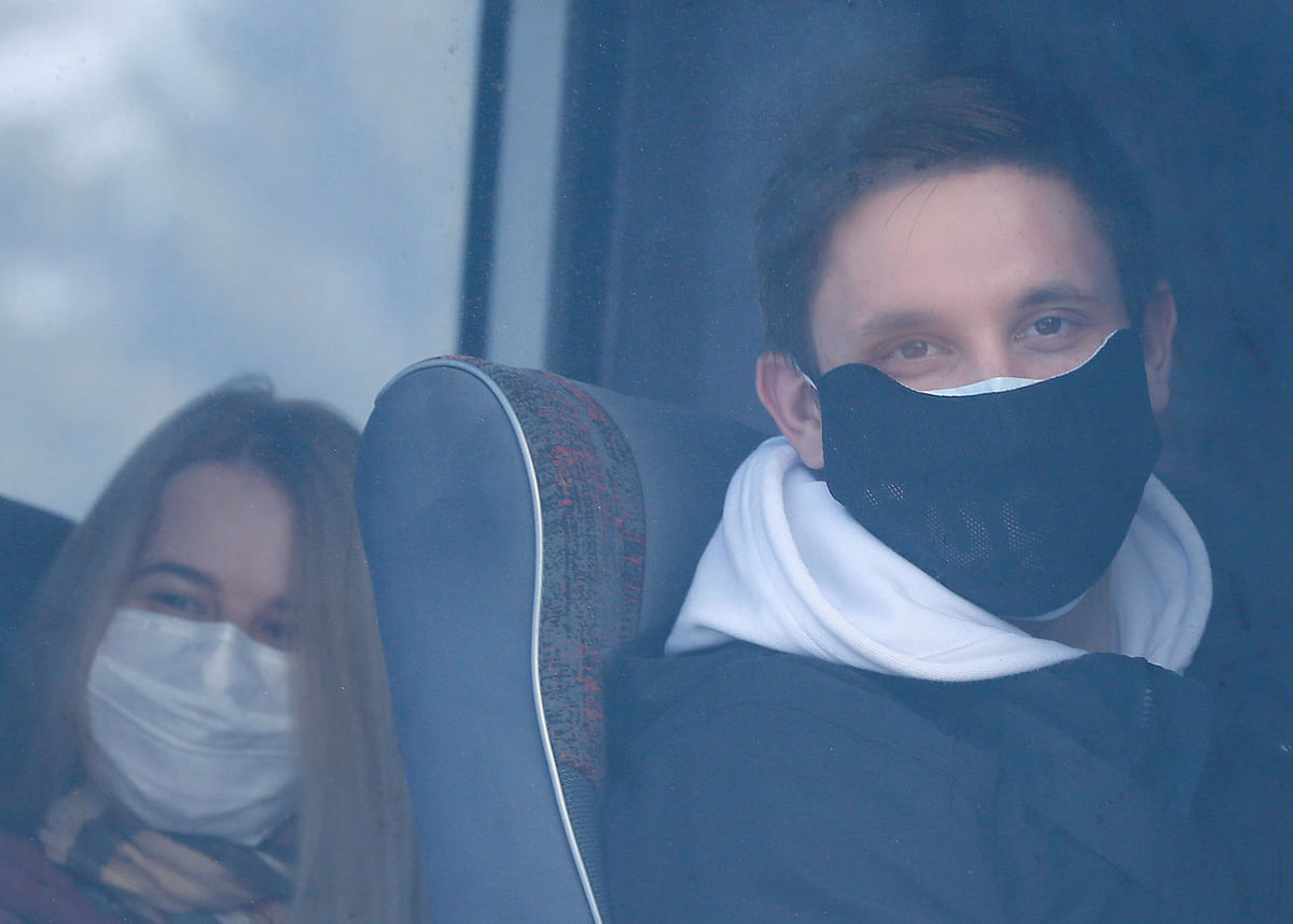 Evacuees, who arrived from China hit by an outbreak of the novel coronavirus, look out of bus windows at an airport in Kharkiv, Ukraine on 20 February 2020. Reuters File Photo