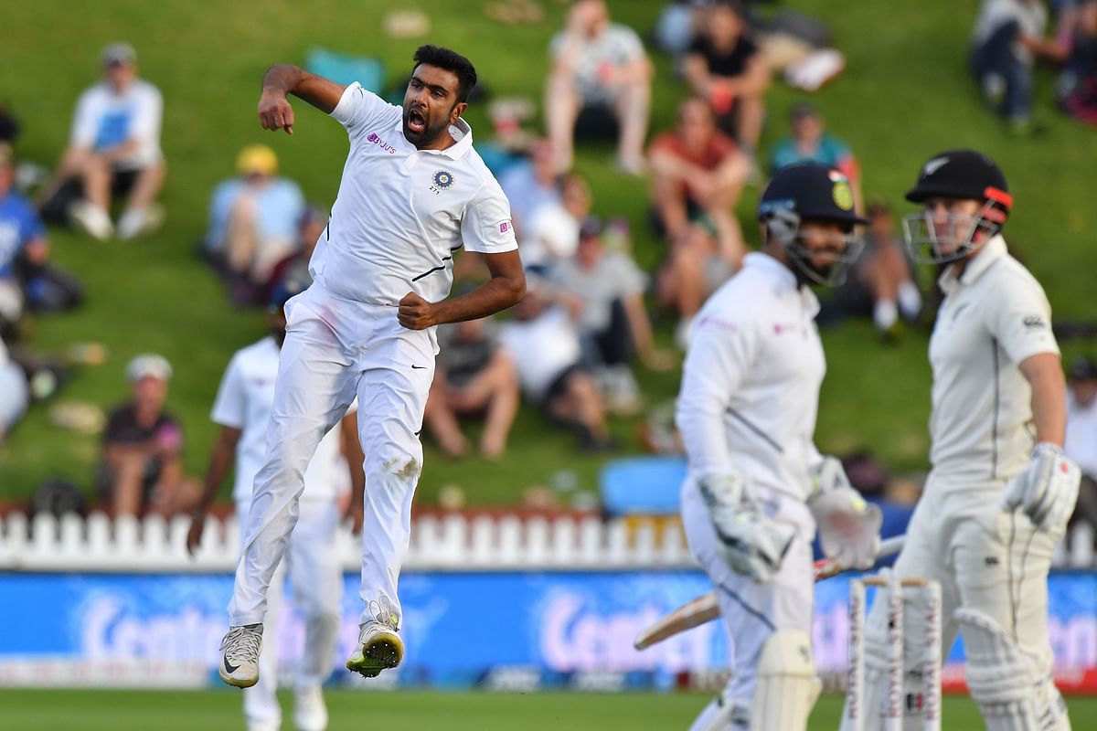 India`s Ravichandran Ashwin (L) celebrates New Zealand`s Henry Nicholls (R) being caught during day two of the first Test cricket match between New Zealand and India at the Basin Reserve in Wellington on 22 February, 2020. Photo: AFP