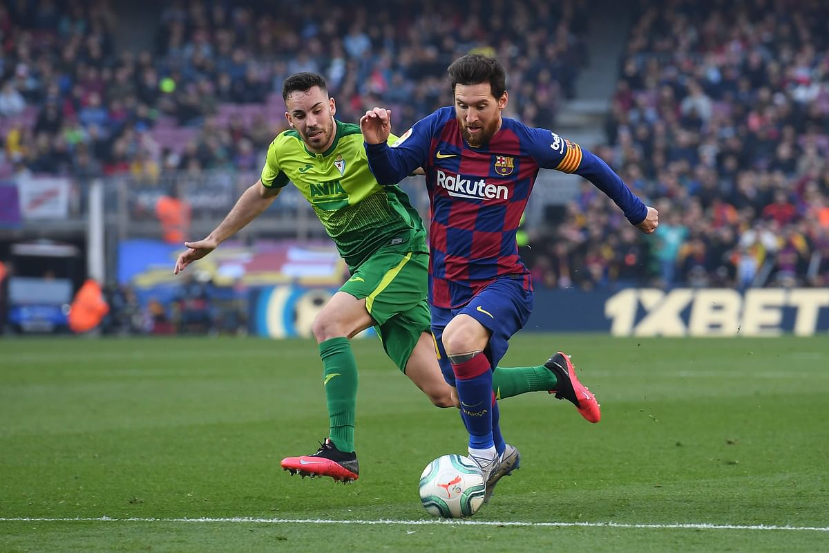 Eibar`s Spanish midfielder Edu Exposito (L) challenges Barcelona`s Argentine forward Lionel Messi during the Spanish league football match FC Barcelona against SD Eibar at the Camp Nou stadium in Barcelona on 22 February 2020. Photo: AFP