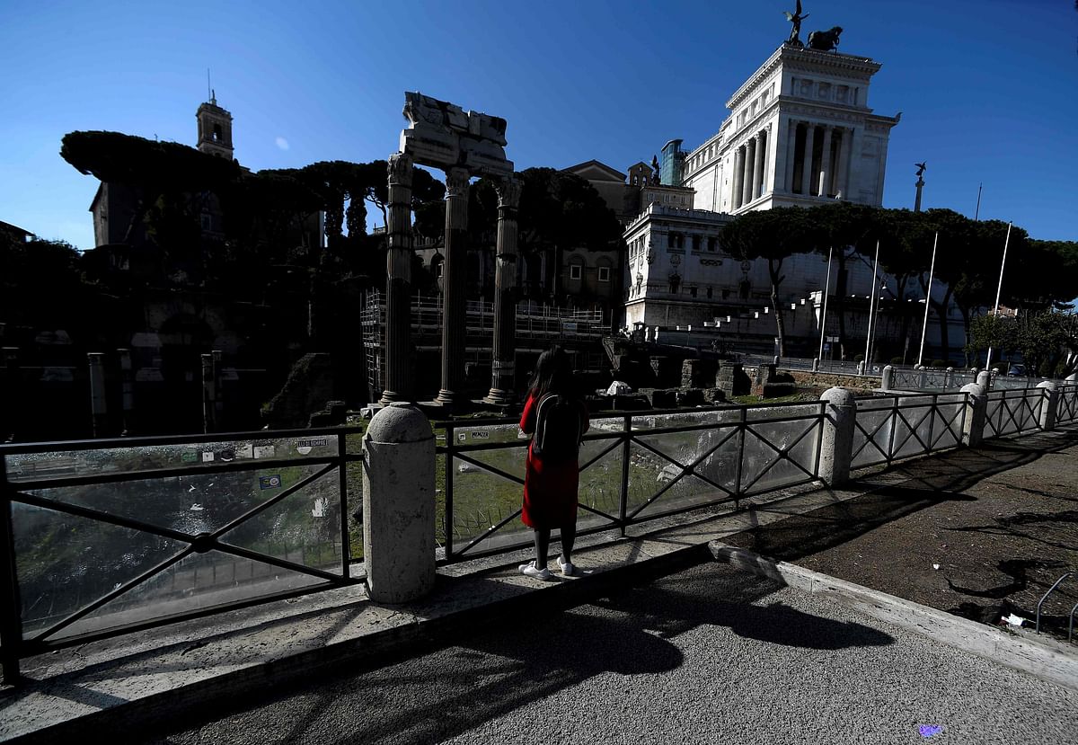 A woman looks at Caesar`s Forum in Rome on 21 February 2020 within the presentation of an ancient tomb thought to belong to Rome`s founder Romulus, discovered under the nearby Roman Forum in the heart of Italy`s capital decades ago. Photo: AFP