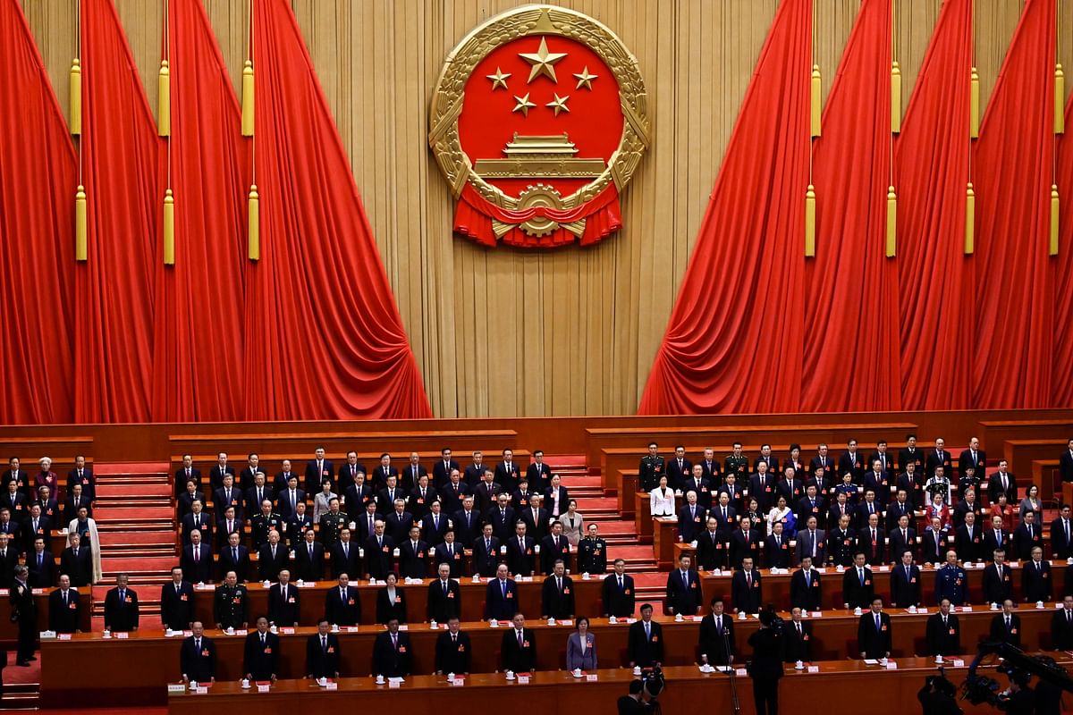 In this file photo taken on 15 March 2019, delegates sing the national anthem during the closing session of the National People`s Congress at the Great Hall of the People in Beijing. China decided on 24 February 2020 to postpone the annual meeting of its parliament due in March for the first time since the Cultural Revolution, as the country fights to contain the coronavirus outbreak, state media reported. Photo: AFP