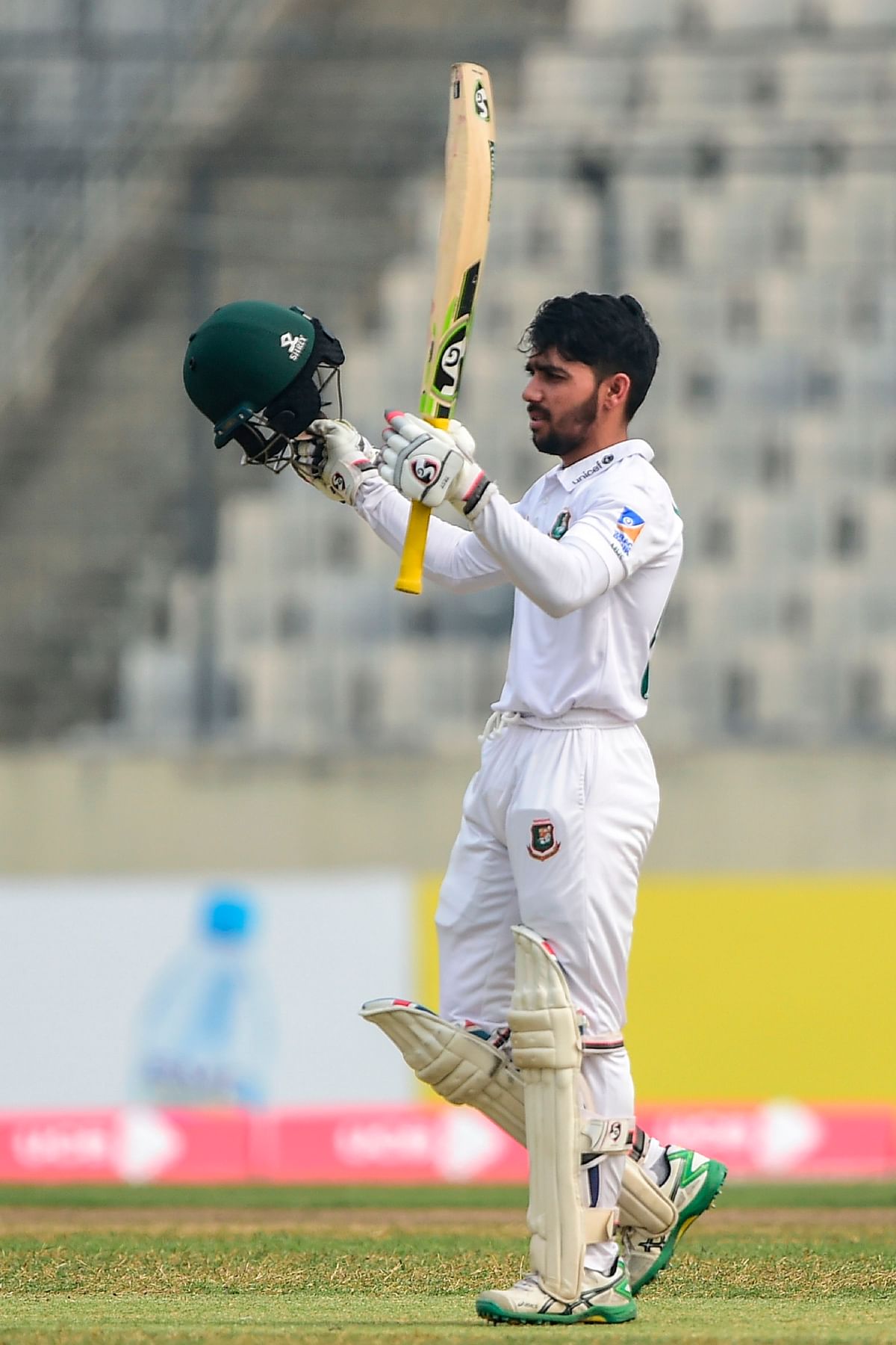 Bangladesh`s captain Mominul Haque rises his bat after scoring a century (100 runs) during the third day of a Test cricket match between Bangladesh and Zimbabwe at the Sher-e-Bangla National Cricket Stadium in Dhaka on 24 February, 2020. Photo: AFP