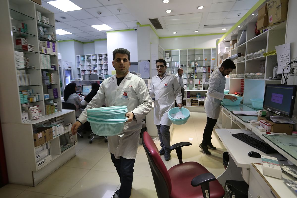 Iranian medical staff work at the state-run `13 Aban` pharmacy in Tehran on 19 February, 2020. Photo: AFP