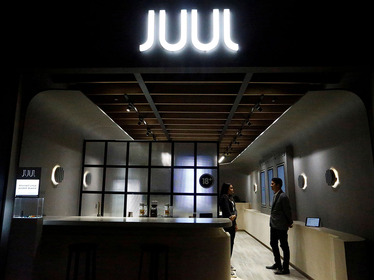 Shopkeepers stand inside a Juul shop at a shopping mall in Jakarta. Photo: Reuters