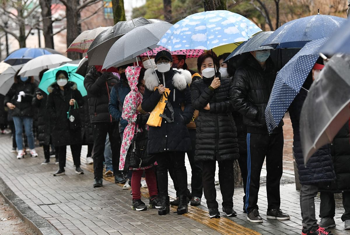 People wait in a line to buy face masks at a retail store in the southeastern city of Daegu on 25 February. Photo: AFP