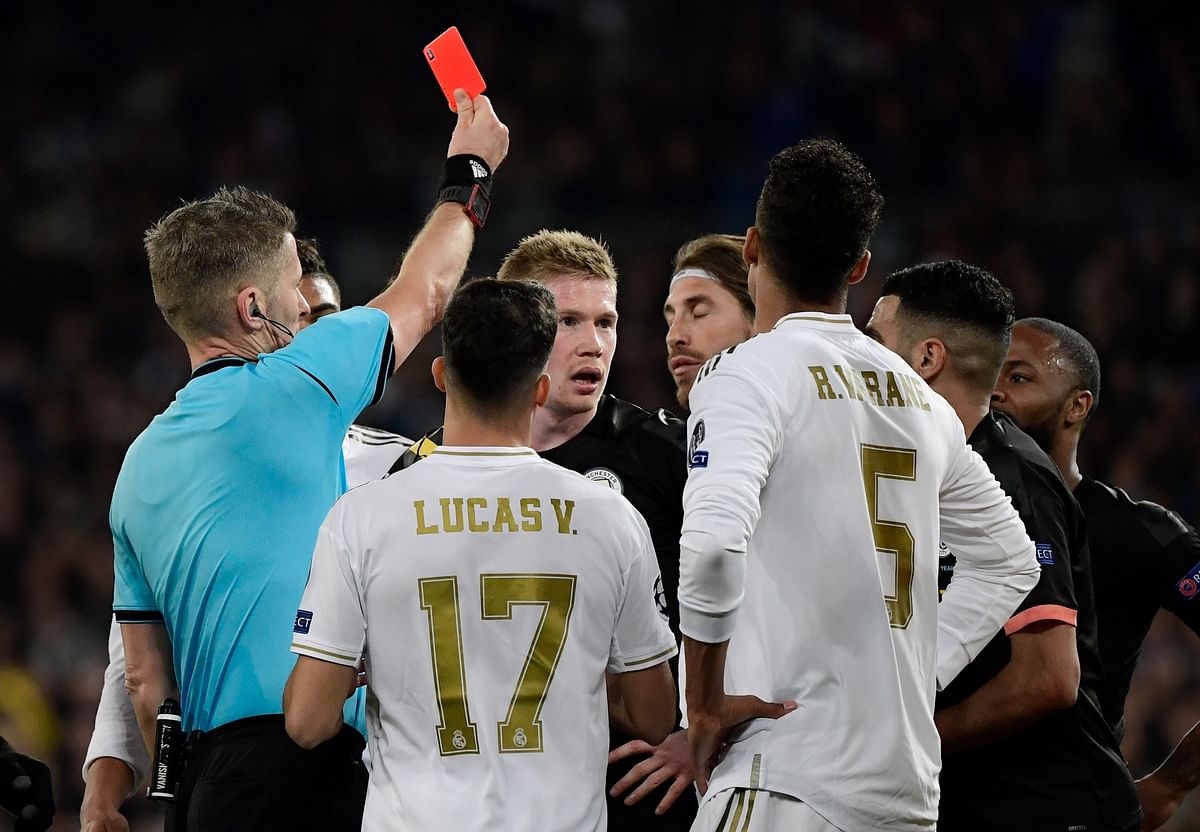 Real Madrid`s Spanish defender Sergio Ramos (C) is handed a red card by Italian referee Daniele Orsato during the UEFA Champions League round of 16 first-leg football match between Real Madrid CF and Manchester City at the Santiago Bernabeu stadium in Madrid on 26 February 2020. Photo: AFP