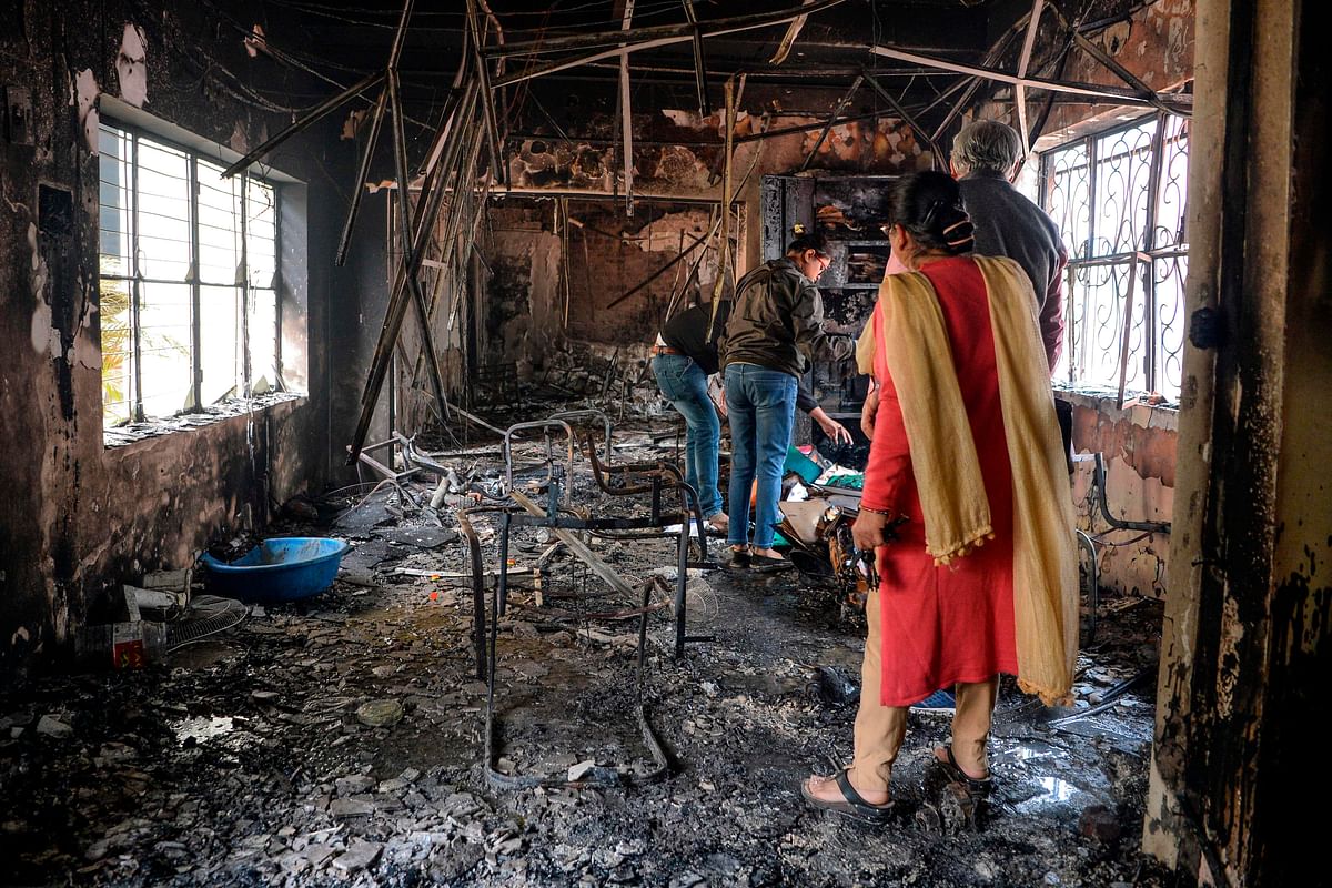 In this file photo taken on 26 February 2020 People inspect the remains of a burnt-out school premises following clashes between people supporting and opposing a contentious amendment to India`s citizenship law, in New Delhi. Photo: AFP