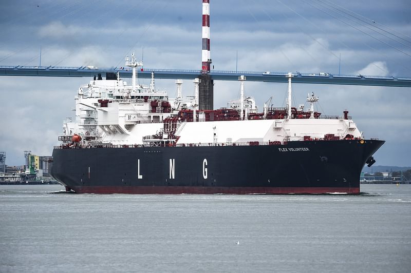 The LNG (liquefied natural gas) tanker Flex Volunteer, sailing under the flag of the Marshall Islands, cruises near the Saint-Nazaire bridge over the Loire estuary, as it leaves the dock of the LNG Terminal of Montoir-de-Bretagne, near Saint-Nazaire, western France, on 12 April , 2022