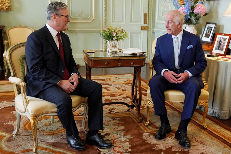 Britain's King Charles III (R) meets with Britain's incoming Prime Minister Keir Starmer during an audience at Buckingham Palace in London on 5 July 2024, a day after Britain held a general election. 