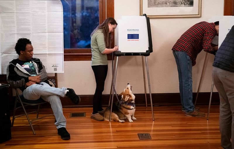 A dog named Daisy looks on as their owner fills out a ballot in a polling place at the Cincinnati Observatory on 5 November 2024 in Cincinnati, Ohio. 