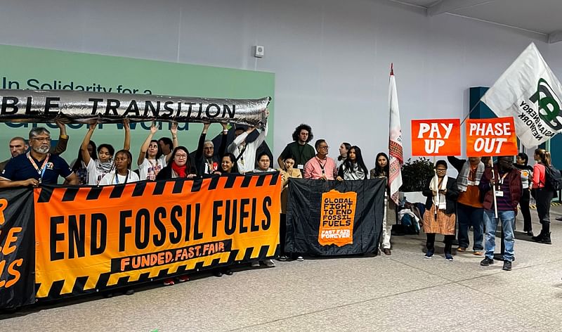 Climate activists stage a protest inside the COP29 venue to demand a phase out of fossil fuels during the United Nations Climate Change Conference (COP29) in Baku on 15 November, 2024.