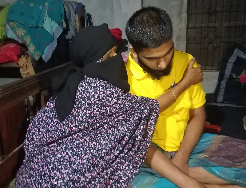 Rahmat Ullah is embraced by his mother as he returns home 16 months after being picked up by RAB men